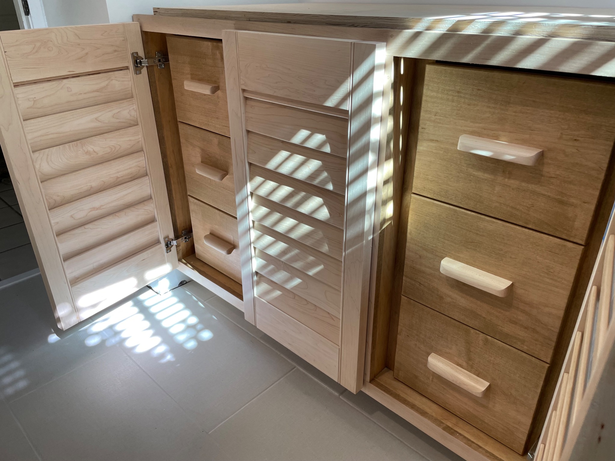 Custom vanity open to show interior drawers and storage
