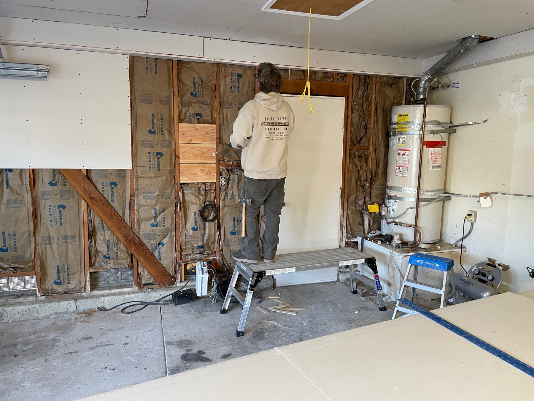 Garage wall opened to exposed framing during demolition