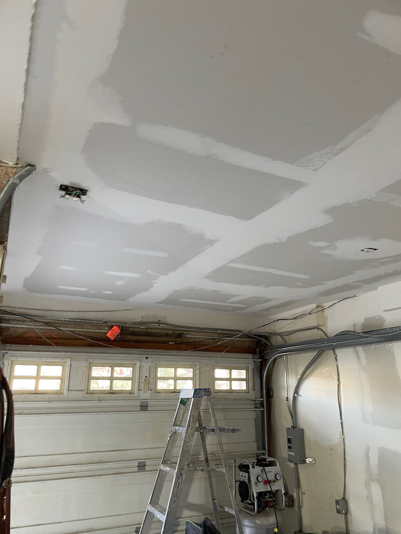 Drywall installation and repair in garage remodel