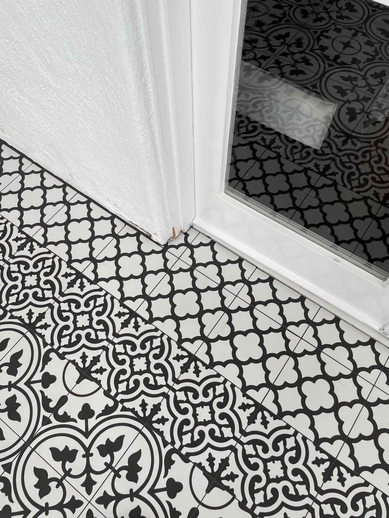 Detailed tile cuts at sunroom doorway